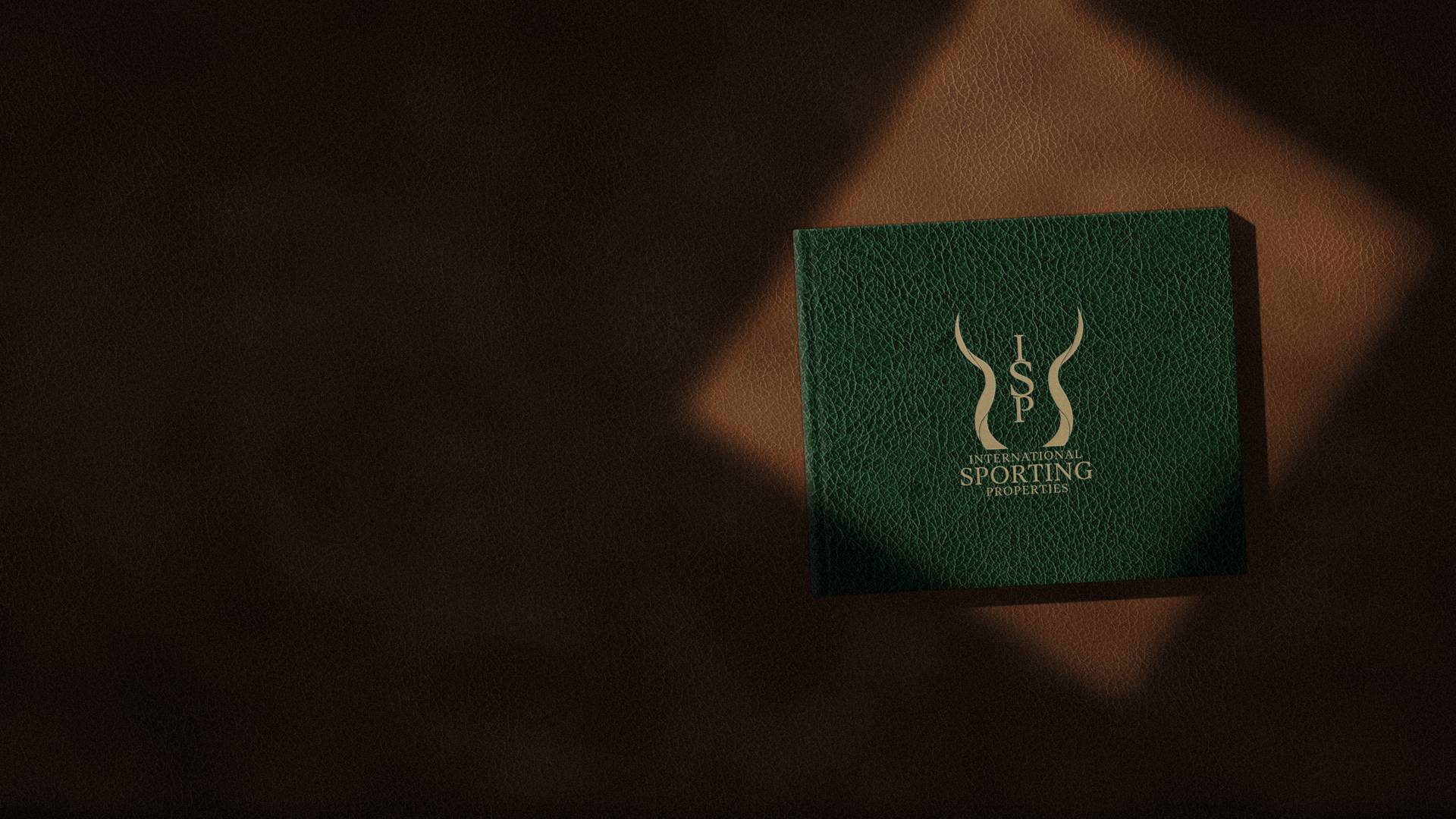 The 2026 Catalogue, bound in green leather, on a desk in afternoon light